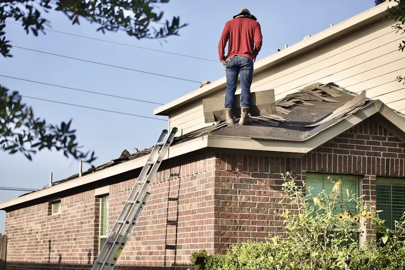 Professional roofer working on a residential roof in Spring Run Manor